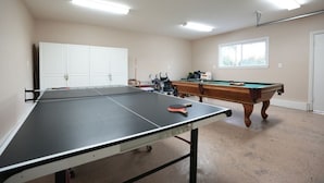 A room with a ping pong table, a pool table, and a white cabinet. - Awesome 4 Bedroom, 3 1/2 Bath Home 1/2 Mile Walk To Disney (Anaheim)