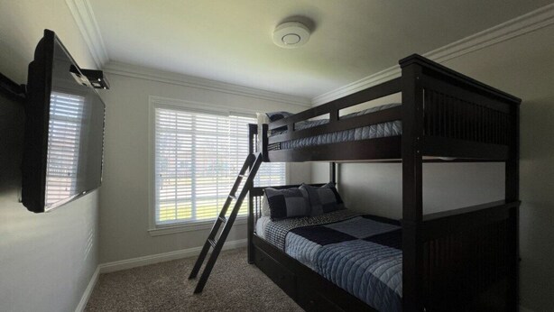 A bunk bed room with a TV mounted on the wall, a window with blinds, and a ceiling light. - Awesome 4 Bedroom, 3 1/2 Bath Home 1/2 Mile Walk To Disney (Anaheim)