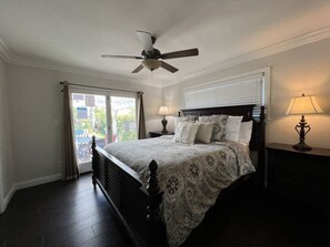 A bedroom with a bed, ceiling fan, two bedside lamps, and a window with curtains. - Awesome 4 Bedroom, 3 1/2 Bath Home 1/2 Mile Walk To Disney (Anaheim)