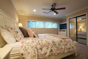 A bedroom with a bed, a ceiling fan, a window, and a dresser. - Incredible Estate 5 Bedrooms 3 Bathroom W/resort Style Rock Pool & Jacuzzi (Fullerton)