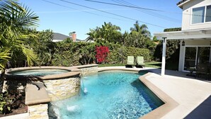 A swimming pool with stone steps, a patio area, and a covered seating area. - Fabulous 6 Bedroom , 4 Bath Pool W/jacuzzi Home (Orange)