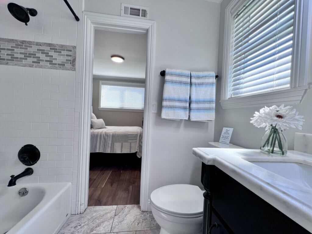 A bathroom with a bathtub, toilet, and sink.