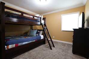 A bunk bed with a ladder, a dresser, and a window with blinds. - Classy 4 Bedroom 3 Bath Pool Home 3/4 Mile Walk To Disney (Anaheim)