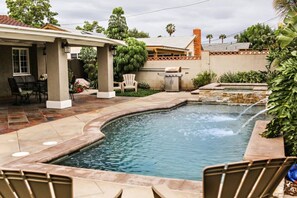 A backyard with a swimming pool, patio furniture, and a barbecue area. - Wonderful 4 Bedroom 3 Bath Pool Home 3/4 Mile To Disney (Anaheim)