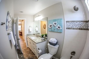 A bathroom with a sink, toilet, and shower. - Adorable 3 Bedroom 2 Bath Home (Fullerton)