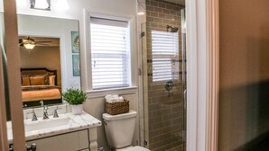 Een badkamer met toilet, wastafel en douche.