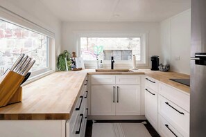 Fridge, stovetop, dishwasher, coffee/tea maker