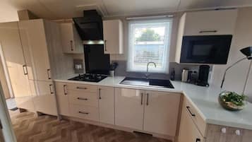 Fridge, microwave, stovetop, coffee/tea maker
