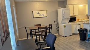 A compact kitchen with white cabinets, a microwave, and a sink. - Cozy 1-bedroom apartment with AC, WiFi and Washer/Dryer in Irving (Irving)