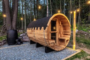 A wooden sauna with a curved roof, surrounded by a forest. - Best Deal in the Poconos! (Tobyhanna)
