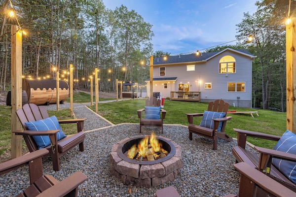 This is  the view from the back corner of the property highlighting a lot of our backyard amenities.  Pocono Mountains Family Friendly & Kid Friendly Amenities, Hot Tub, Sauna, Fire Pit, Grill, Game room, Gaming stations, Pool, Ski, Hike