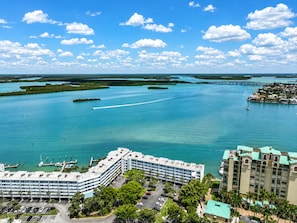 A coastal hotel with multiple parking levels, a marina, and a view of the surrounding water and islands.