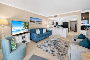 A living room with a TV, sofa, and coffee table.