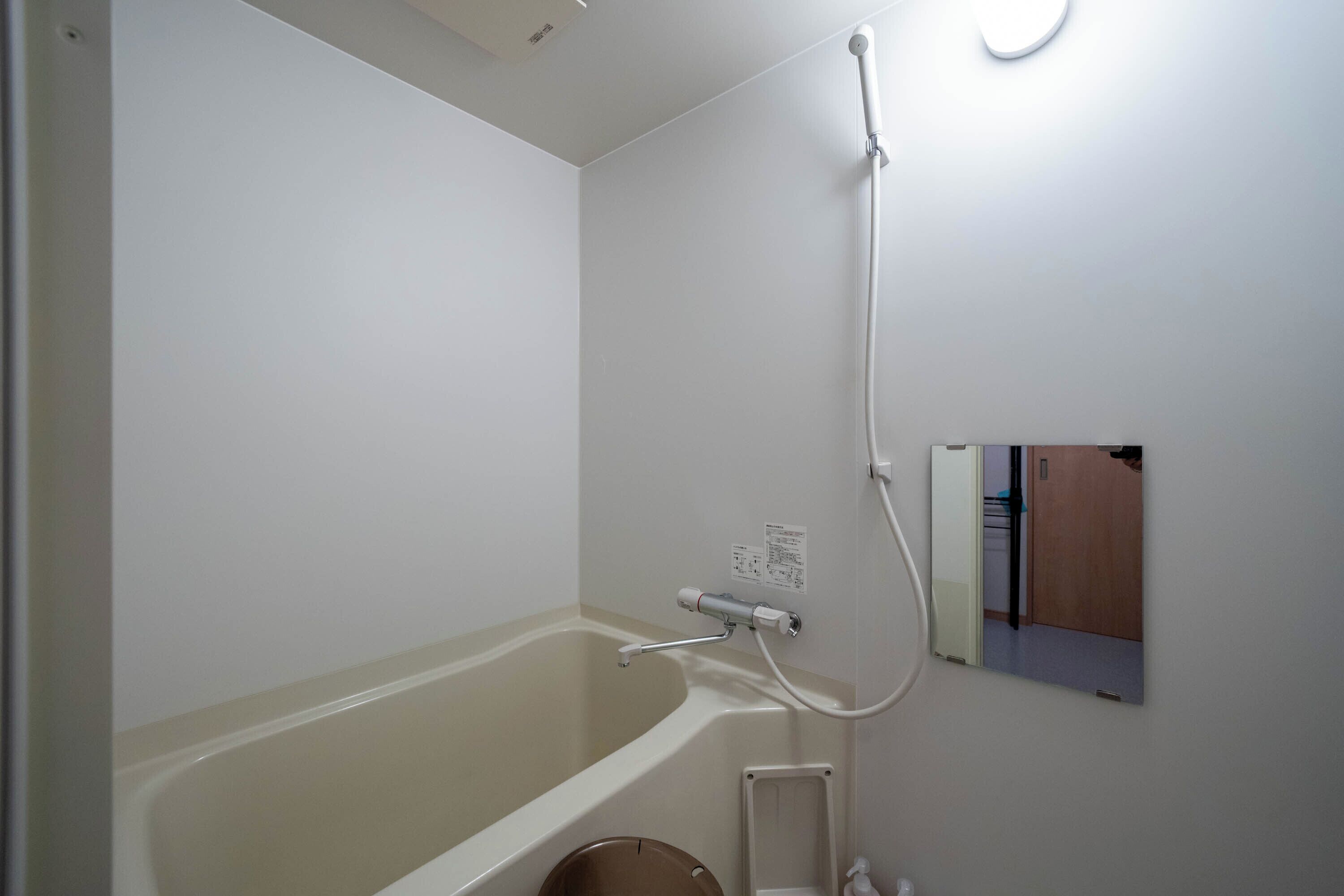 A bathroom with a bathtub, a shower, and a toilet.