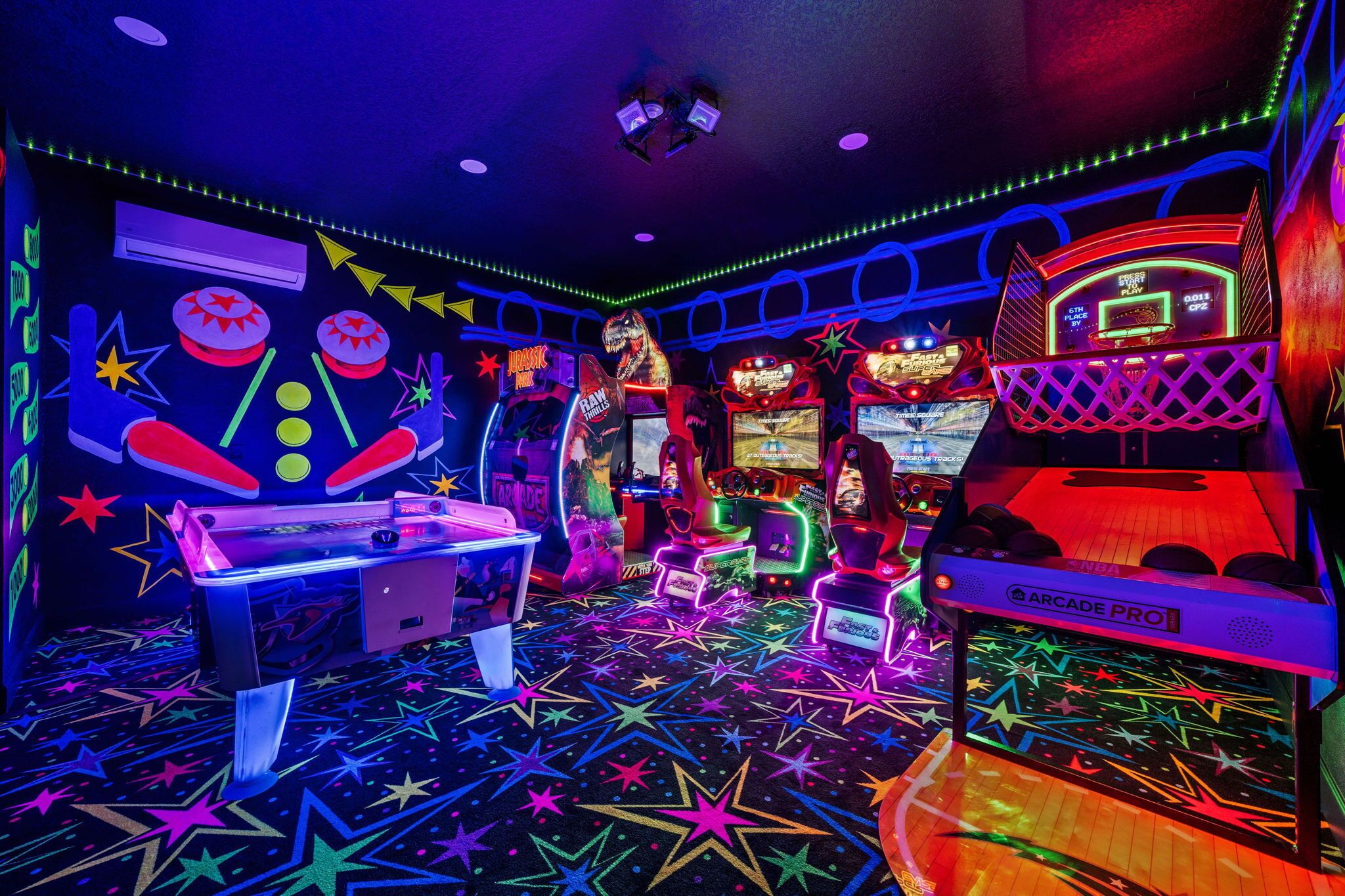A brightly lit arcade room with neon lights, various gaming machines, and a star-patterned floor.