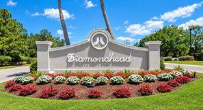 A sign with the name 'Diamondhead' surrounded by a landscaped garden with various flowers.