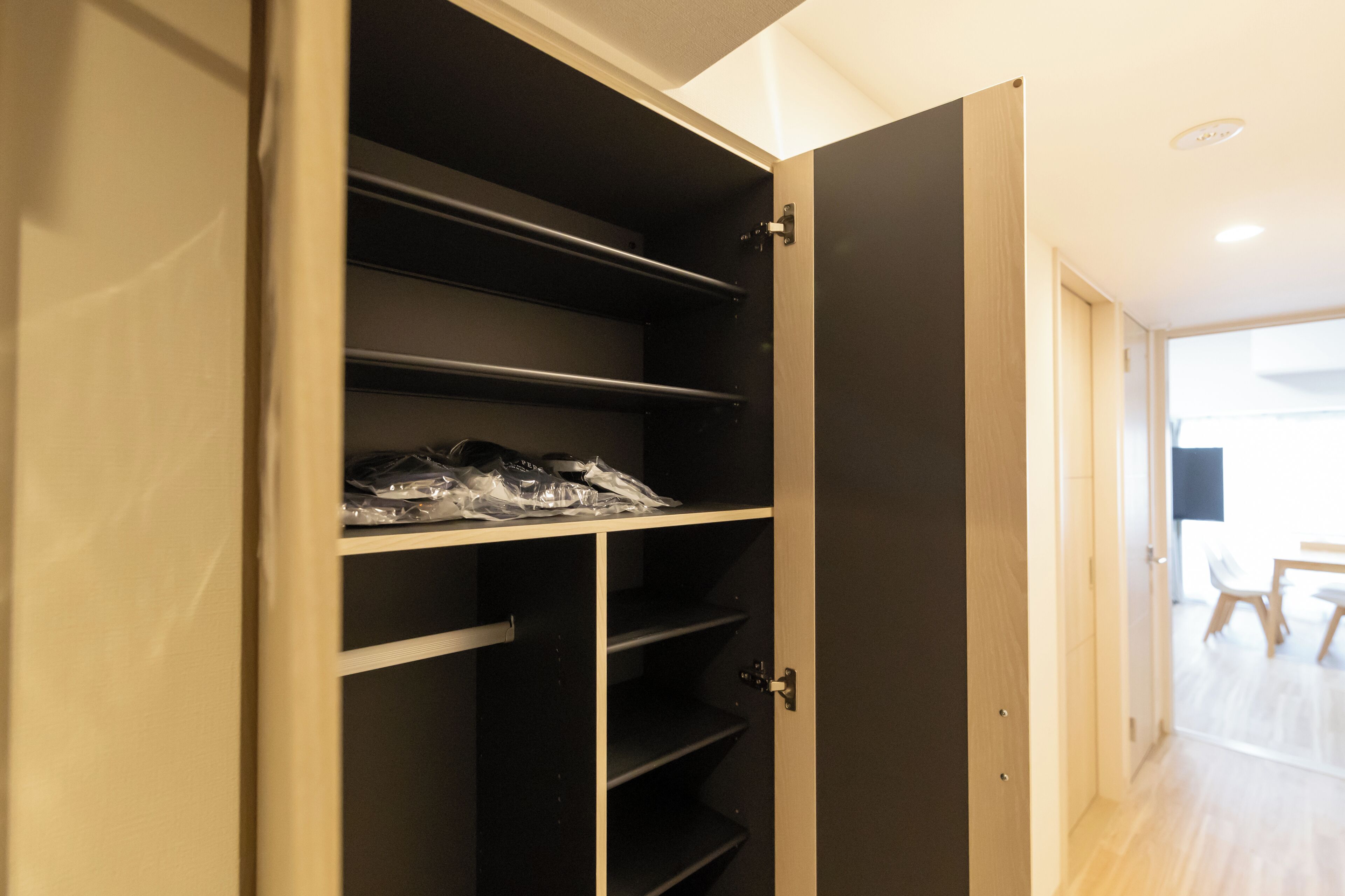 Een open kast met meerdere planken en een deur.