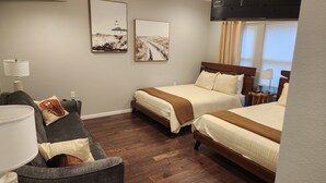 A hotel room with two beds, a sofa, a lamp, and artwork on the walls. - 3-bedroom house located near Camdenton. Nestled In Old Kinderhook community.  (Camdenton)