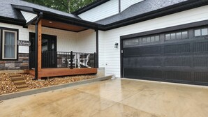A house with a covered porch, a garage, and a driveway. - 3-bedroom house located near Camdenton. Nestled In Old Kinderhook community.  (Camdenton)