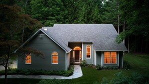 A two-story house with a sloped roof, a front porch, and a well-maintained lawn. - Perfect Nature Haven In Great Barrington (Great Barrington)
