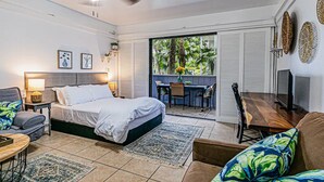 A bedroom with a bed, a desk, a chair, and a TV. - Waiakea Villas Gem. Shared Pool & Private Balcony!
 (Hilo)