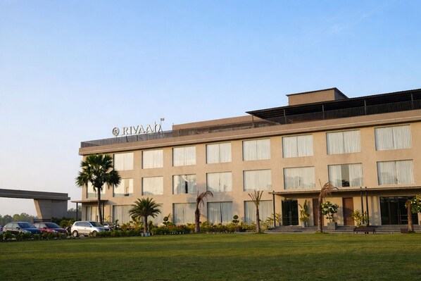 A modern hotel with a flat roof, multiple windows, and a sign reading 'RIVAAH'. - Rivaah Resort (Golmuri)