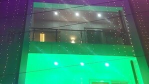A hotel with multiple floors, illuminated by colorful lights. The sign indicates it is a hotel with rooms available for booking. - HOTEL ARAB INN (Mohali)