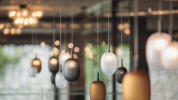 A series of pendant lights with a textured design, hanging from a ceiling in a well-lit indoor space.