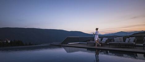 Relax by the serene pool, surrounded by breathtaking mountain views.