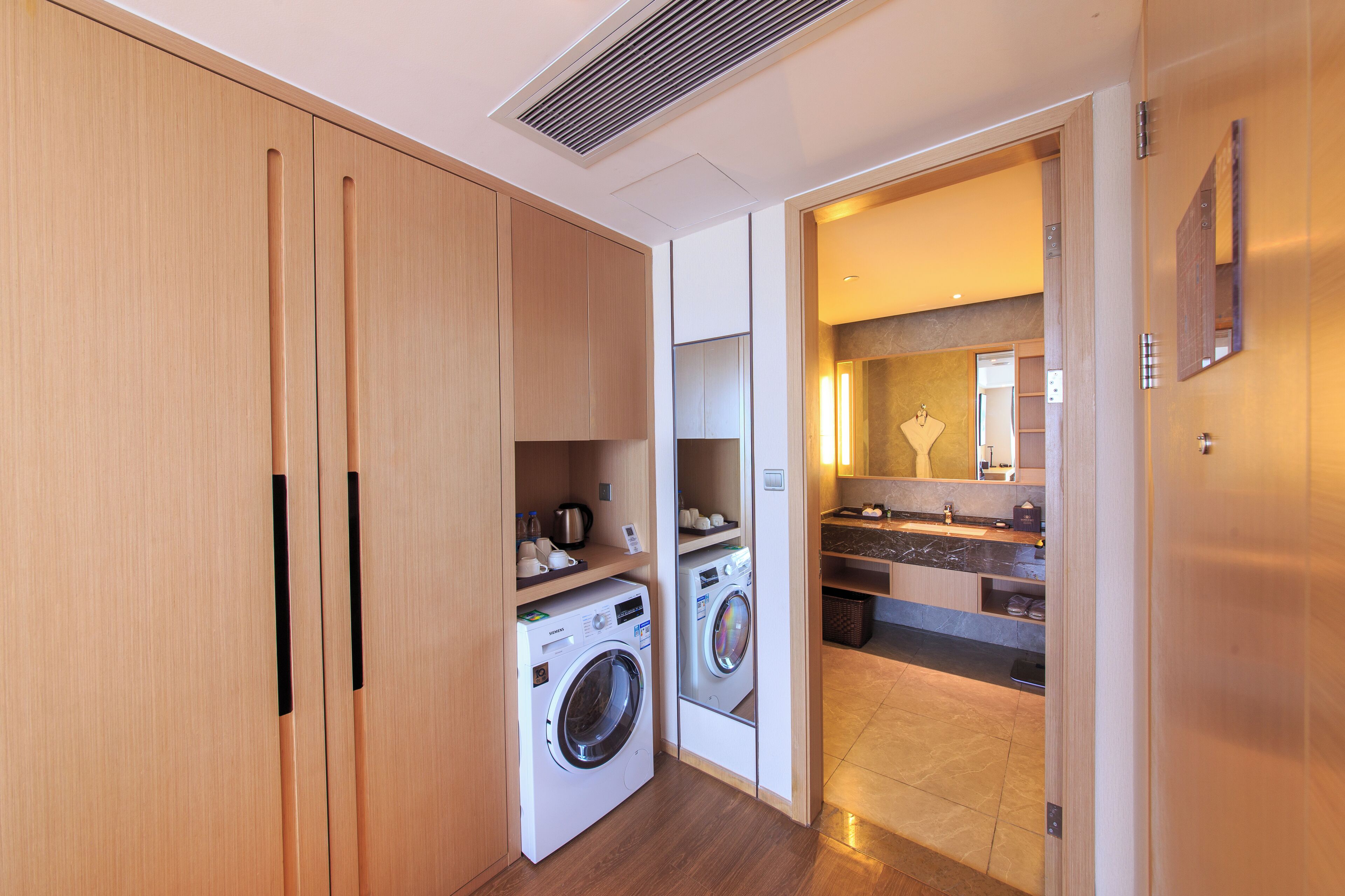 A compact, modern kitchen with built-in appliances and a small dining area.