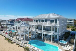 Relax by the pool or unwind in the hot tub, surrounded by ocean views from the covered outdoor area with a gazebo.