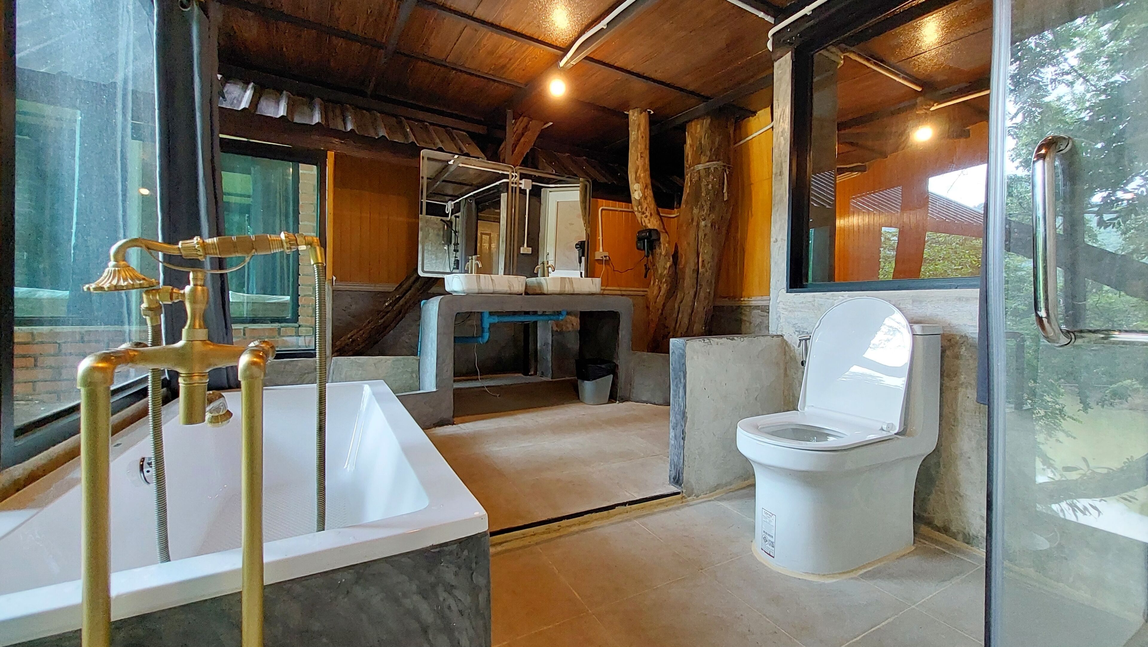 A bathroom with a white sink, a toilet, and a shower area.