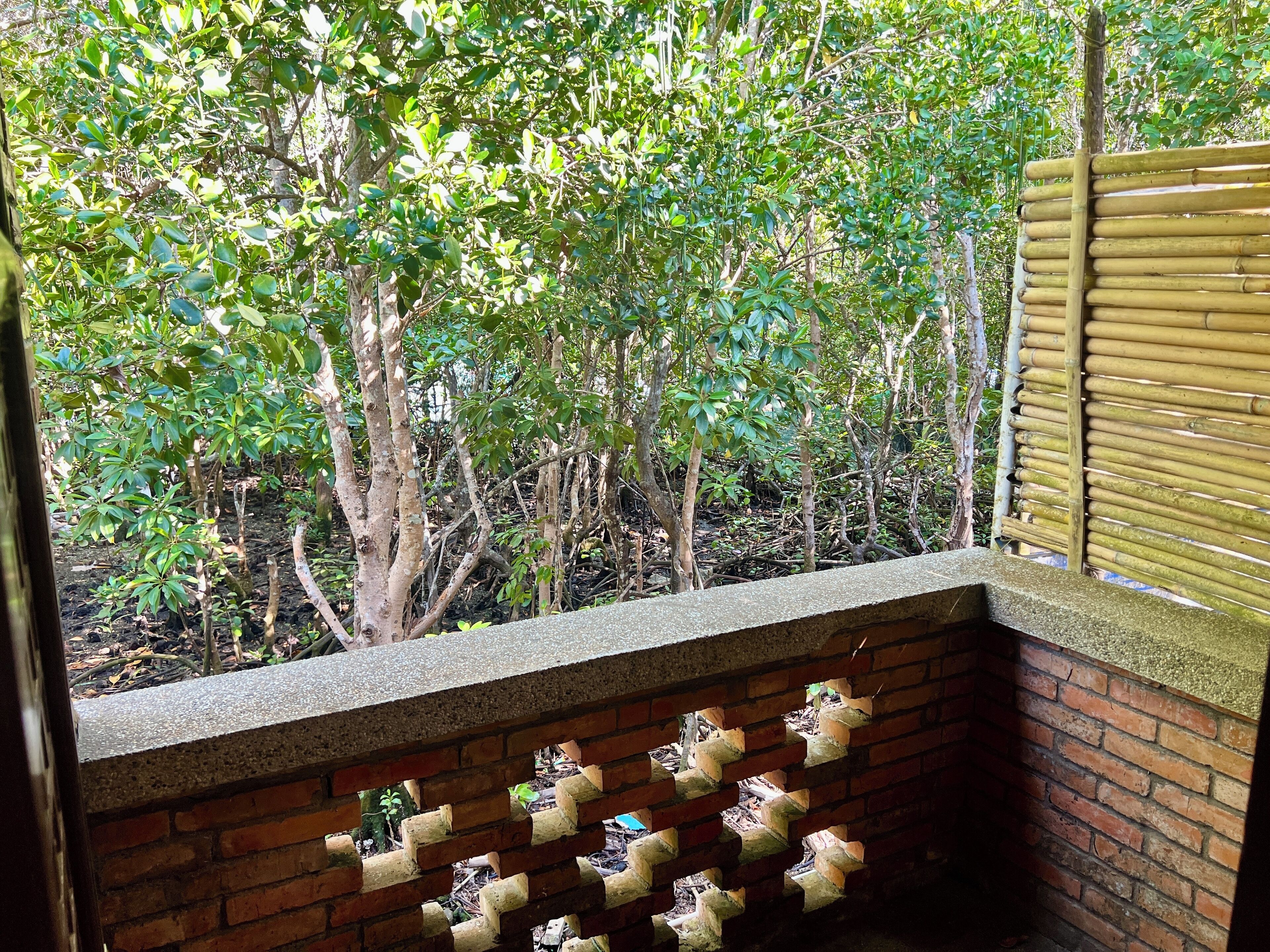 A brick wall with a series of small, white figurines arranged in a grid pattern.