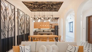 A modern interior with a dining area, kitchen, and living space.