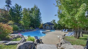A swimming pool with lounge chairs and a house in the background. - Mont Blanc Classic Chalet • Ski-in/Ski-out (Mont Blanc)