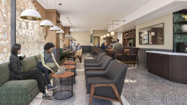 Eine moderne Hotelhalle mit Sitzbereichen, einer Bar und einer Rezeption.