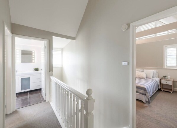 A bedroom with a bed, bedside table, and a window. - Wild Duck Holiday Home at Rafferty's Resort (Cams Wharf)