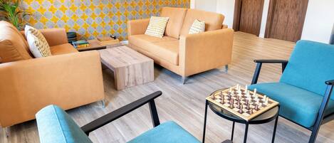 A modern living room with a sofa set, a coffee table, and a chess table.