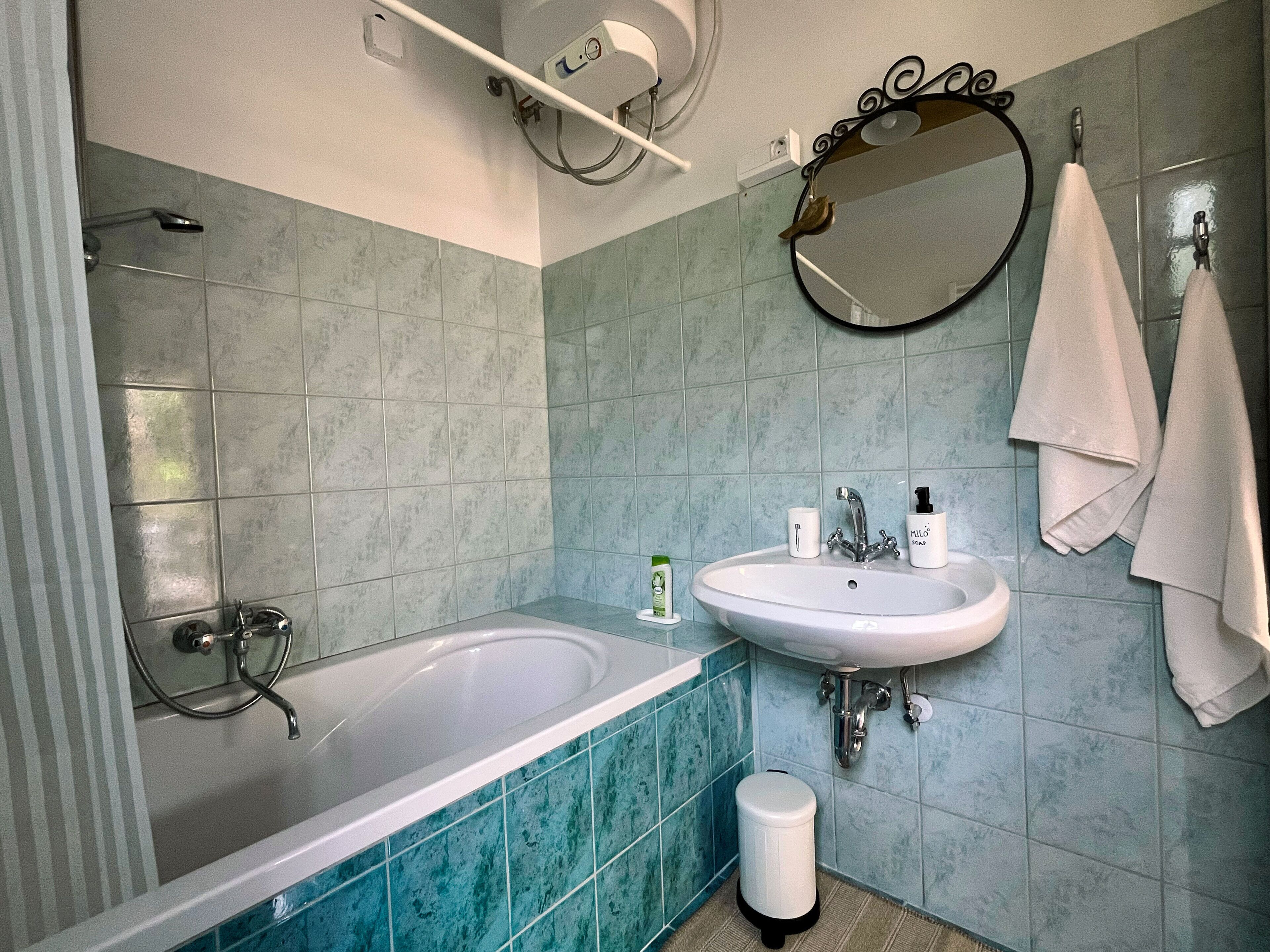 A bathroom with a bathtub, a sink, and a toilet.