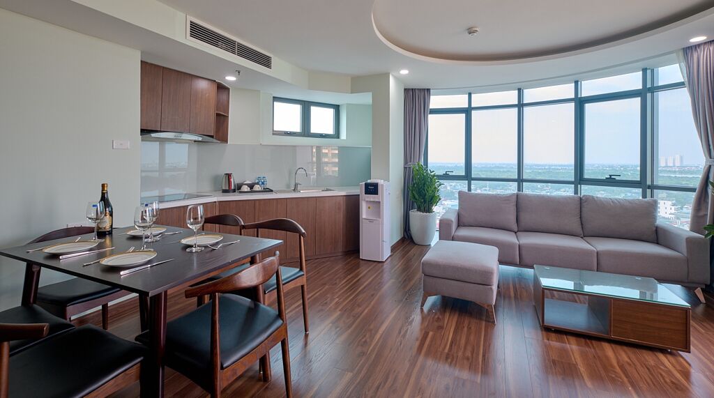 Deluxe Apartment, Balcony, City View | Living area | 55-inch flat-screen TV with cable channels