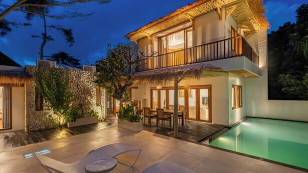 A two-story house with a pool, outdoor seating, and a thatched roof. - Peaceful Luxe Villa near Beach in Pecatu (Pecatu)