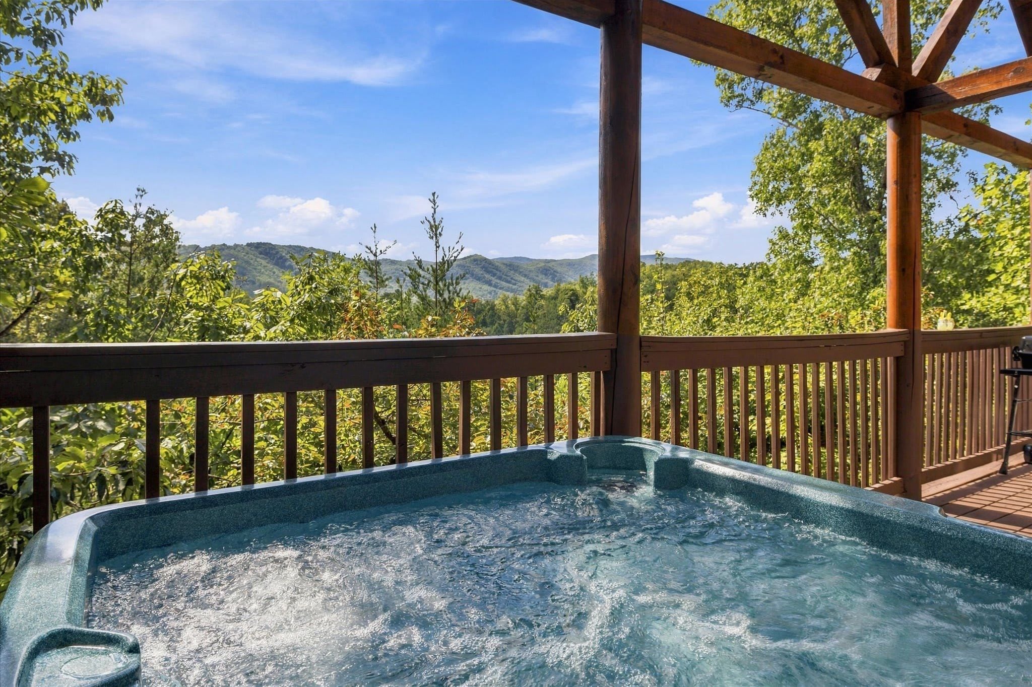Relax in the private hot tub beneath the mountain sky.