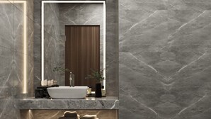Un baño moderno con un lavabo de mármol, un espejo, un inodoro y un zapatero.