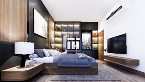 Un dormitorio moderno con una cama grande, mesitas de noche, un televisor y un armario con estantes iluminados.