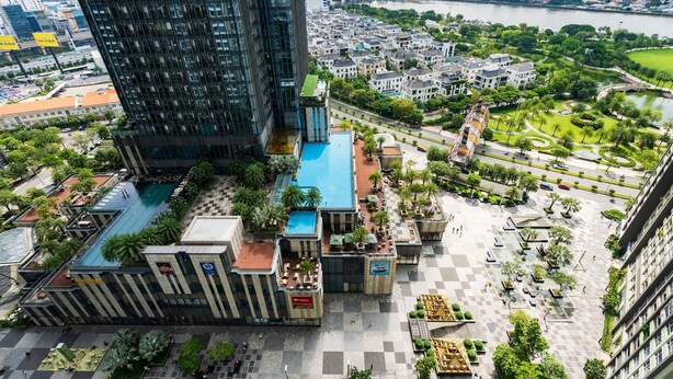 A high-rise building with a rooftop pool and outdoor seating areas. - Vinhomes Central Park Luxury - Leminbo (Ho Chi Minh City)