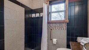 A bathroom with a shower, toilet, and sink. - Double the Comfort | Travel Together (Prescott)
