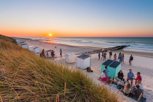 Affordable comfort for groups — 9 private rooms for a restful stay near the beach.