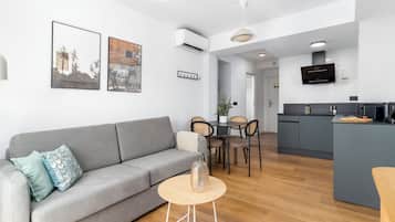 One-Bedroom Apartment with Balcony | Living area | 50-inch flat-screen TV with cable channels