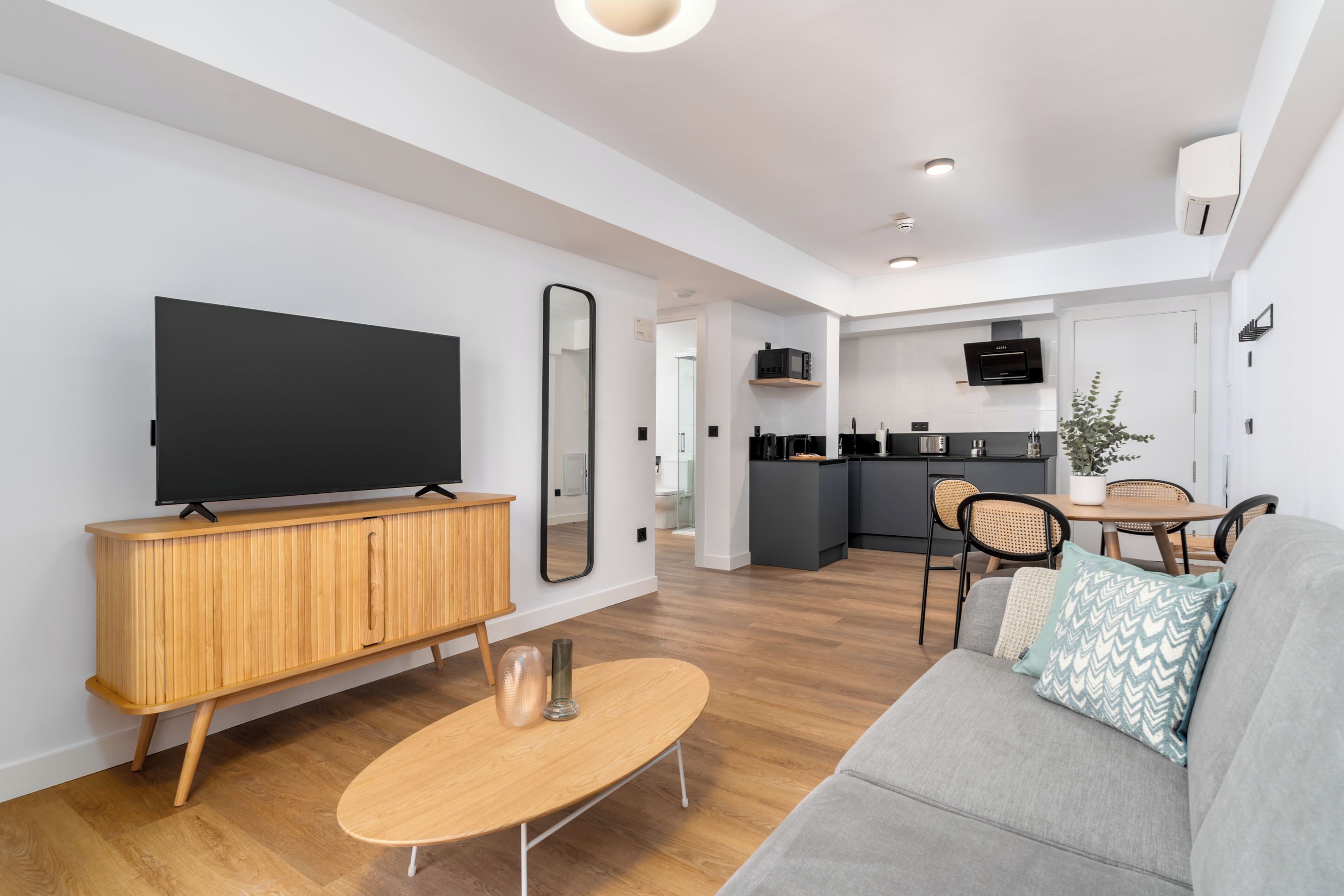 One-Bedroom Comfort Apartment + Balcony | Living area | 50-inch flat-screen TV with cable channels