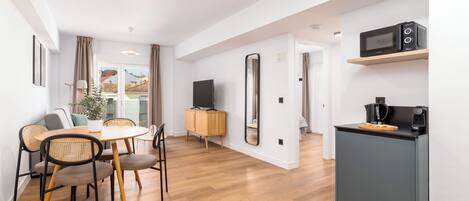 One-Bedroom Comfort Apartment + Balcony | Living area | 50-inch flat-screen TV with cable channels
